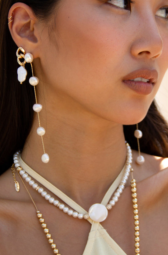 Dripping Pearl Delicate Drop Earrings on a model 